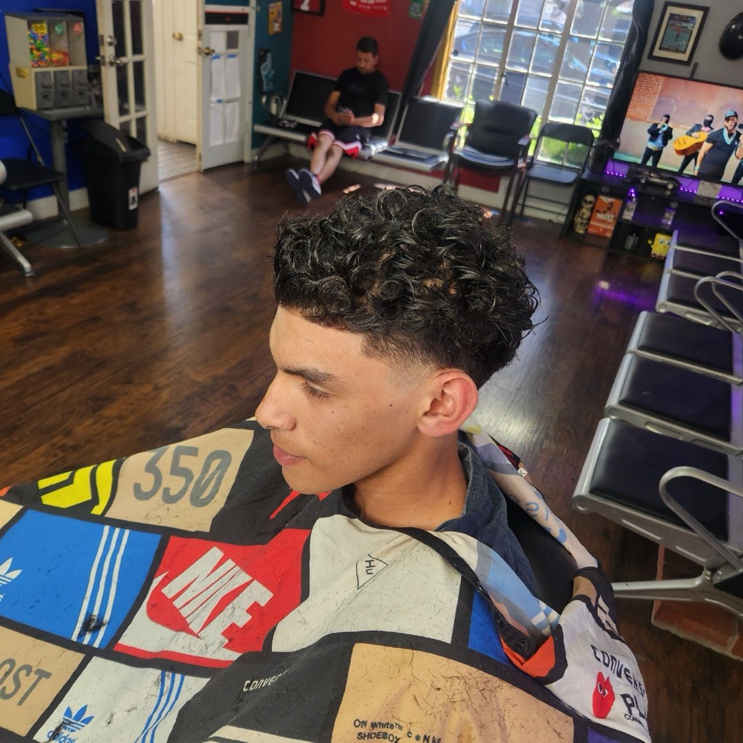 Curly top with a tapered skin fade at Sees Barbershop, Concord, CA