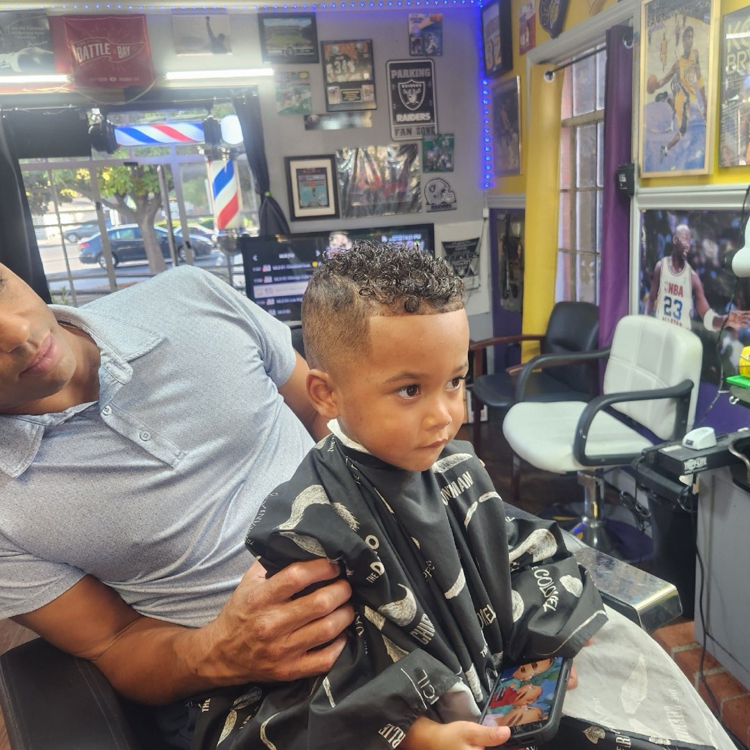 Toddler's first haircut with curly top at Sees Barbershop, Concord, CA