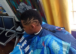 Kid's curly top with shaved star designs at Sees Barbershop, Concord, CA
